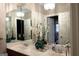 Bright bathroom featuring double sinks, large mirrors, decorative lighting, and modern fixtures at 5188 Ashley Se Dr, Covington, GA 30014
