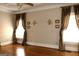 Well-lit bedroom featuring hardwood floors, neutral colors, and large windows at 5188 Ashley Se Dr, Covington, GA 30014