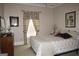 Comfortable bedroom with a bed, window with decorative curtains, and neutral wall colors at 5188 Ashley Se Dr, Covington, GA 30014
