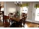 Dining room featuring a wooden table and chairs, a window view, and overhead light fixtures at 5188 Ashley Se Dr, Covington, GA 30014