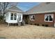 Back exterior view of a brick home with a sunroom and deck at 5188 Ashley Se Dr, Covington, GA 30014