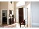 Inviting foyer with high ceilings, tile floor, and dark wood door with decorative glass panes at 5188 Ashley Se Dr, Covington, GA 30014