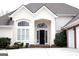 Inviting front entrance featuring an arched doorway and decorative windows in a bright and well maintained home at 5188 Ashley Se Dr, Covington, GA 30014