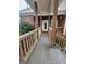 Inviting brick home featuring a charming front porch with wood railings and supports at 5188 Ashley Se Dr, Covington, GA 30014