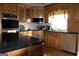 Large kitchen features custom cabinets, countertops, stainless steel appliances, and hardwood floors at 5188 Ashley Se Dr, Covington, GA 30014