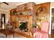 Cozy living room with a brick fireplace, wooden built-ins, and hardwood floors at 5188 Ashley Se Dr, Covington, GA 30014