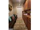Well-organized mud room with wooden bench, coat rack, overhead cabinets, and patterned rug at 5188 Ashley Se Dr, Covington, GA 30014