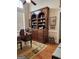 Well-lit office with a large wooden bookcase, desk, and a view from a window at 5188 Ashley Se Dr, Covington, GA 30014