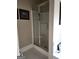 Bathroom featuring a shower with glass doors and tile surround at 5188 Ashley Se Dr, Covington, GA 30014