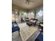A sunroom with floor rugs and blue chairs, bathed in natural light at 5188 Ashley Se Dr, Covington, GA 30014