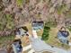An aerial view showcases the house surrounded by trees and other houses in a serene neighborhood in the forest at 204 Eleanor Ct, Stockbridge, GA 30281