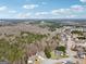 An aerial view displays the house in the serene environment, surrounded by trees and peaceful community atmosphere at 204 Eleanor Ct, Stockbridge, GA 30281