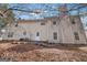 Back exterior of home view featuring a patio and tree lined backyard at 204 Eleanor Ct, Stockbridge, GA 30281