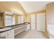 Bright bathroom featuring a double sink vanity, ample counter space, soaking tub and neutral finishes at 204 Eleanor Ct, Stockbridge, GA 30281