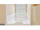 Bright and clean bathroom bathtub with showerhead and white tile surround at 204 Eleanor Ct, Stockbridge, GA 30281