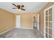 Bedroom with neutral carpet, ceiling fan, access to bathroom, and French door at 204 Eleanor Ct, Stockbridge, GA 30281