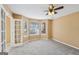 Carpeted bedroom featuring ample natural light from multiple windows and a ceiling fan at 204 Eleanor Ct, Stockbridge, GA 30281