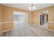 Dining room with new carpet, elegant chandelier, and open access to other living spaces at 204 Eleanor Ct, Stockbridge, GA 30281