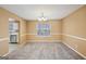 Bright dining room with new carpet, a window, chandelier and open access to the kitchen at 204 Eleanor Ct, Stockbridge, GA 30281