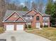 Beautiful two-story brick home with two-car garage, gray shingle roof and a well-manicured lawn at 204 Eleanor Ct, Stockbridge, GA 30281