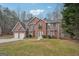 Striking two-story brick home with a lush lawn, gray roof, and convenient two-car garage at 204 Eleanor Ct, Stockbridge, GA 30281
