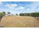 Large community field surrounded by a fence and mature trees at 204 Eleanor Ct, Stockbridge, GA 30281