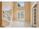 Bright foyer featuring a grand staircase, tiled flooring, double french doors, and high ceilings at 204 Eleanor Ct, Stockbridge, GA 30281