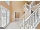 Inviting foyer with staircase, tile flooring, and a view into the carpeted living space at 204 Eleanor Ct, Stockbridge, GA 30281