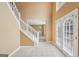 Bright foyer featuring a grand staircase, tiled flooring, double french doors, and high ceilings at 204 Eleanor Ct, Stockbridge, GA 30281