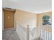 Upstairs hallway and staircase featuring a window at 204 Eleanor Ct, Stockbridge, GA 30281