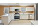 Modern kitchen features white cabinets, white countertops, stainless steel appliances, and tiled flooring at 204 Eleanor Ct, Stockbridge, GA 30281