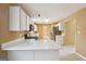 Open kitchen with white cabinets, stainless steel appliances, and view to living room at 204 Eleanor Ct, Stockbridge, GA 30281