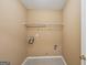 A simple laundry room with tile floors and single wire shelf at 204 Eleanor Ct, Stockbridge, GA 30281