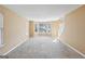 Inviting living room features multiple windows that fill the space with natural light and plush carpeting at 204 Eleanor Ct, Stockbridge, GA 30281