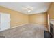View of a spacious living room with neutral walls, soft carpeting and a glimpse of the fireplace at 204 Eleanor Ct, Stockbridge, GA 30281