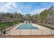 Community pool area with pool house amid a backdrop of trees and blue sky at 204 Eleanor Ct, Stockbridge, GA 30281