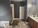 Bathroom featuring a soaking tub, shower, double vanity, tile floors, and neutral paint at 4371 Minkslide Sw Dr, South Fulton, GA 30331