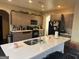 Open kitchen featuring a large island with bar seating and modern appliances at 4371 Minkslide Sw Dr, South Fulton, GA 30331