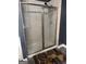 Close-up of a tiled shower with glass doors and neutral paint at 4371 Minkslide Sw Dr, South Fulton, GA 30331