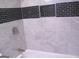 Updated bathroom with black tile accents, shower niche, and tub with chrome fixtures at 5017 Galbraith Cir, Stone Mountain, GA 30088