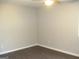 Spacious bedroom featuring hardwood floors, neutral paint, and ceiling fan at 5017 Galbraith Cir, Stone Mountain, GA 30088