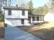 Charming two-story home showcasing a well-maintained lawn, a long driveway, and a cozy porch for relaxing at 5017 Galbraith Cir, Stone Mountain, GA 30088