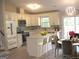 Well-lit kitchen boasts white cabinets, stainless steel appliances, an island with bar seating, and stylish backsplash at 5017 Galbraith Cir, Stone Mountain, GA 30088
