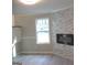 Bright living room with modern fireplace, white trim, and luxury vinyl flooring at 5017 Galbraith Cir, Stone Mountain, GA 30088