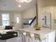 Bright, open-concept living space with modern furnishings and a view of the staircase at 5017 Galbraith Cir, Stone Mountain, GA 30088