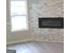 Bright living room with modern fireplace, white trim, and luxury vinyl flooring at 5017 Galbraith Cir, Stone Mountain, GA 30088