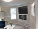 The living room boasts a stone fireplace, modern lighting, and a large television at 5017 Galbraith Cir, Stone Mountain, GA 30088
