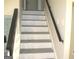Staircase with dark banister and neutral colors throughout the home at 5017 Galbraith Cir, Stone Mountain, GA 30088