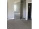 Bedroom featuring a closet with sliding mirrored doors, carpet, and neutral color paint at 5626 Pine Gate Pine Gate Dr, Atlanta, GA 30349