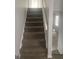 Carpeted staircase leading to upper floors with freshly painted walls and natural lighting at 5626 Pine Gate Pine Gate Dr, Atlanta, GA 30349